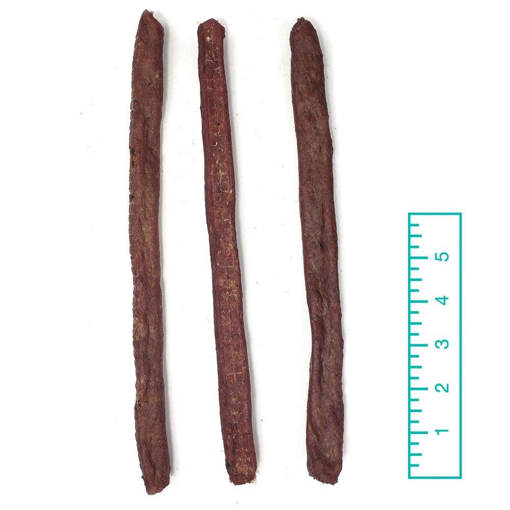 Bully Snaps medium texture beef chew sticks for dogs next to ruler