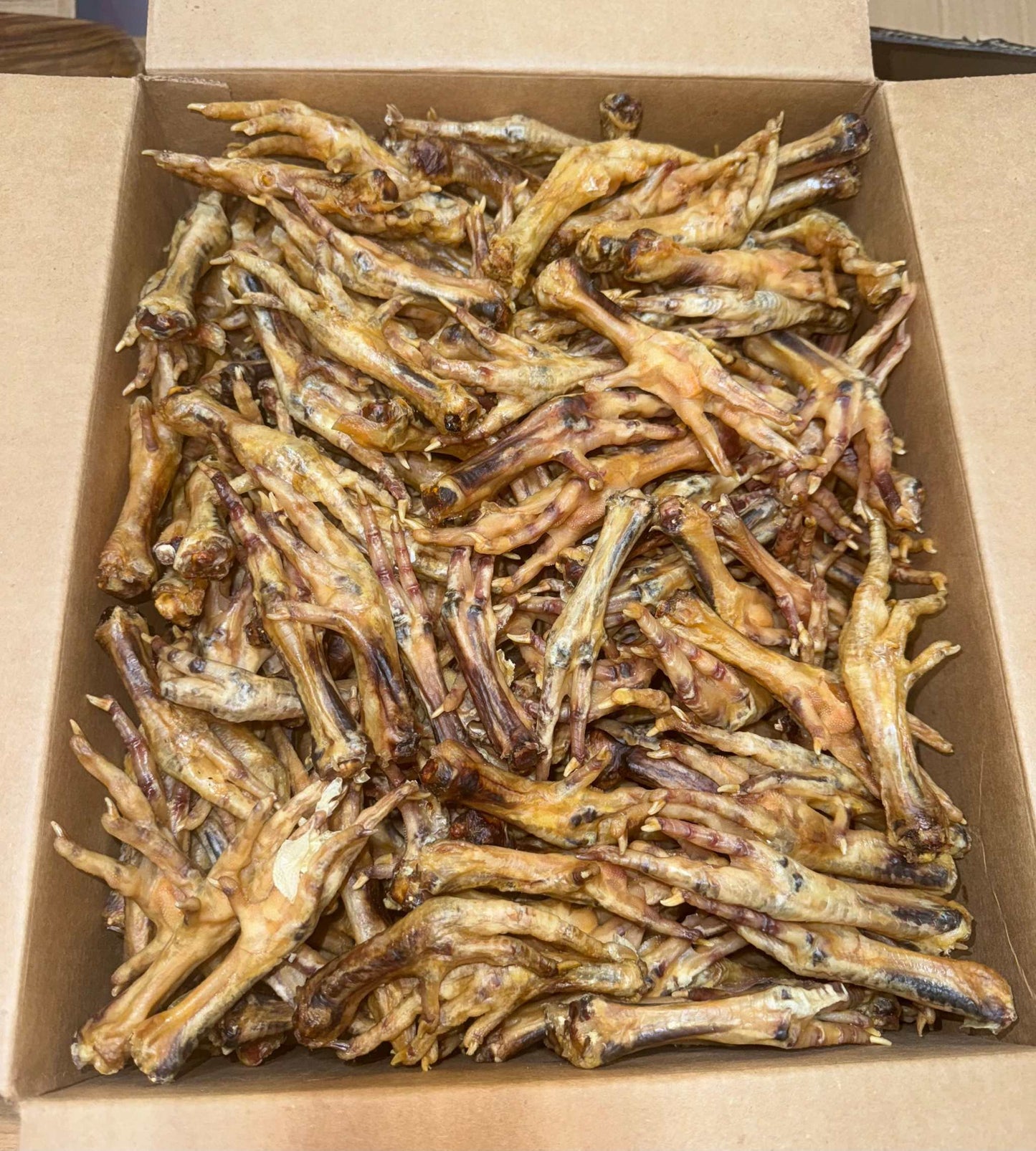 10 lb case of dried chicken feet for dogs, promoting joint and dental health.