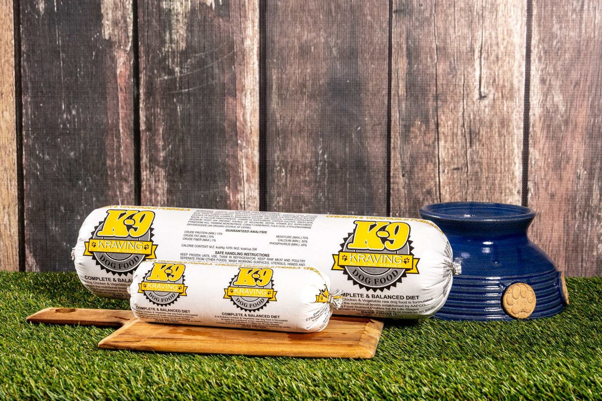 K-9 Kraving Chicken & Vegetable Formula Raw Dog Food on grass with blue dog bowl.