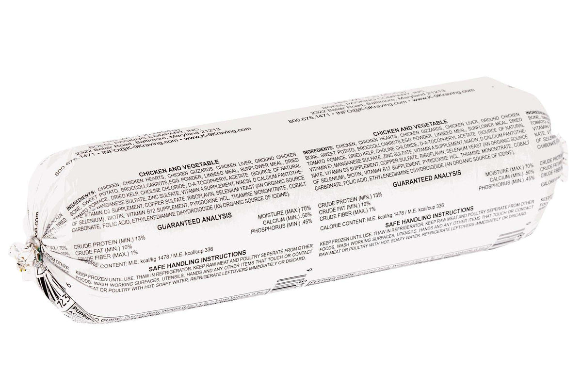 Frozen raw dog food roll in white plastic packaging with dense black ingredient and nutrition text, labeled Chicken and Vegetables.