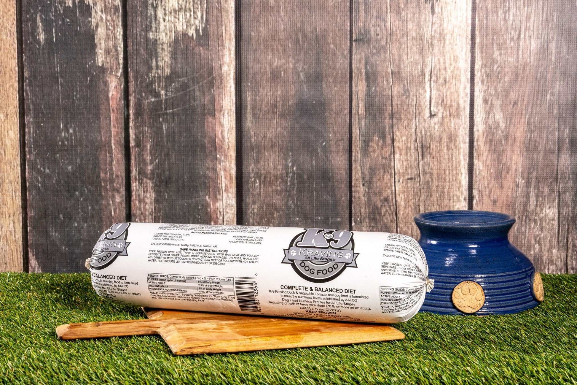 K-9 Kraving Duck & Vegetable Formula Raw Dog Food on wooden board with feeding bowl.