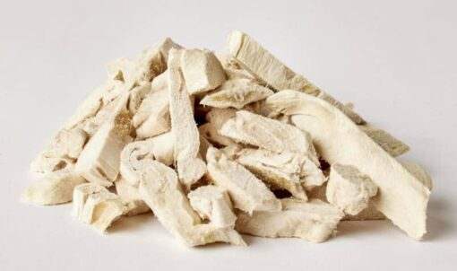 Freeze dried rabbit tenders piled on white background.