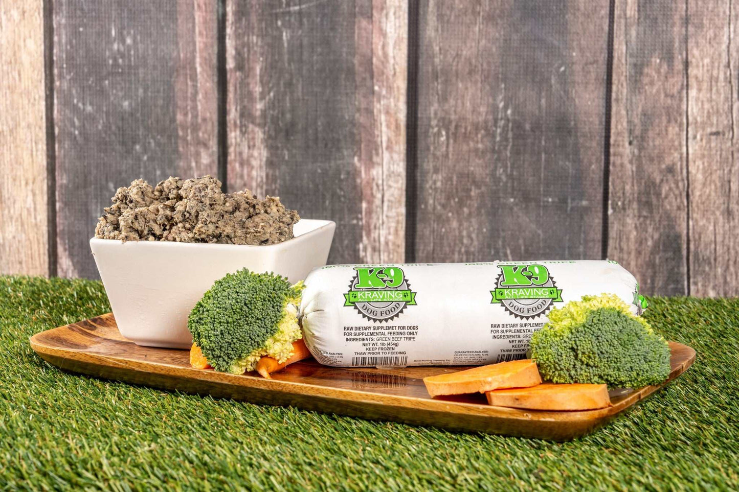 K-9 Kraving Green Tripe with fresh vegetables on a wooden tray.