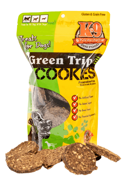 Green Tripe K-9 Cookies in colorful packaging with scattered dog treats.