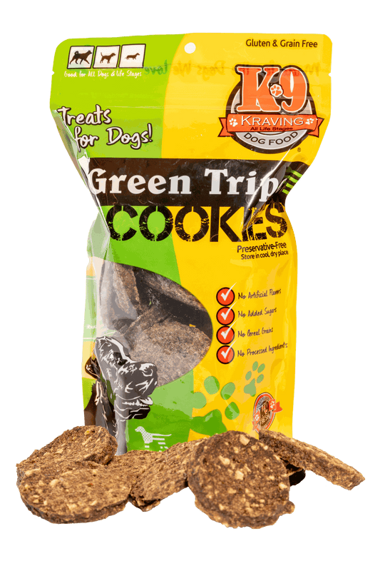 Green Tripe K-9 Cookies in colorful packaging with scattered dog treats.