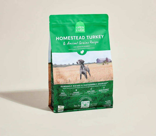 Green bag of Open Farm Homestead Turkey & Ancient Grain Recipe dog kibble with image of a dog in a field and farm in background