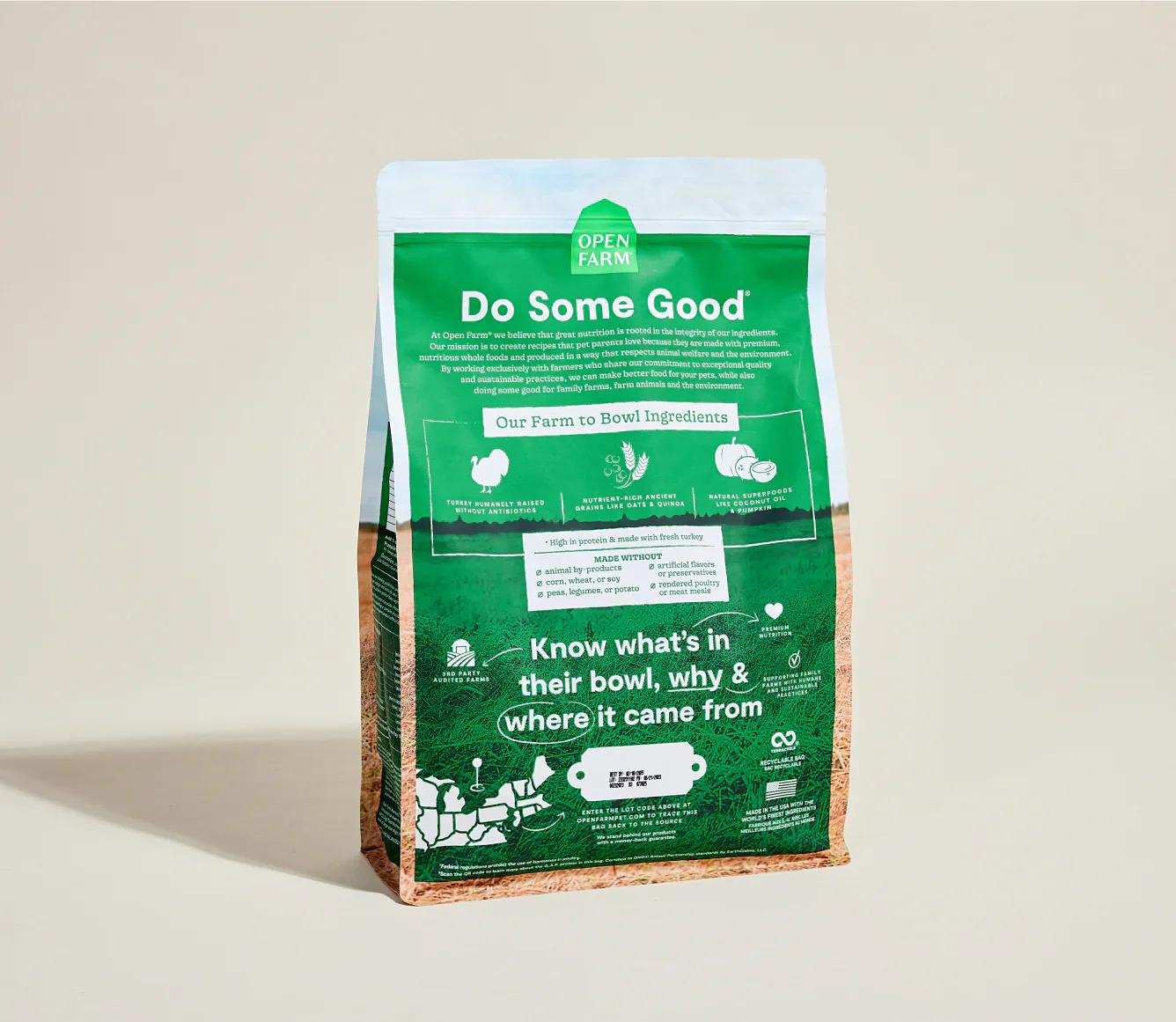 Green and brown package of Homestead Turkey & Ancient Grain Recipe dog kibble with farm-to-bowl ingredient information and eco-friendly claims