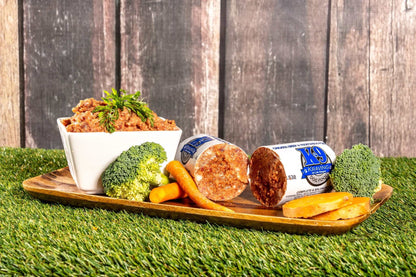 K-9 Kraving Chicken Beef & Vegetable Formula Raw Dog Food with broccoli, carrots, and sweet potatoes displayed on a tray.