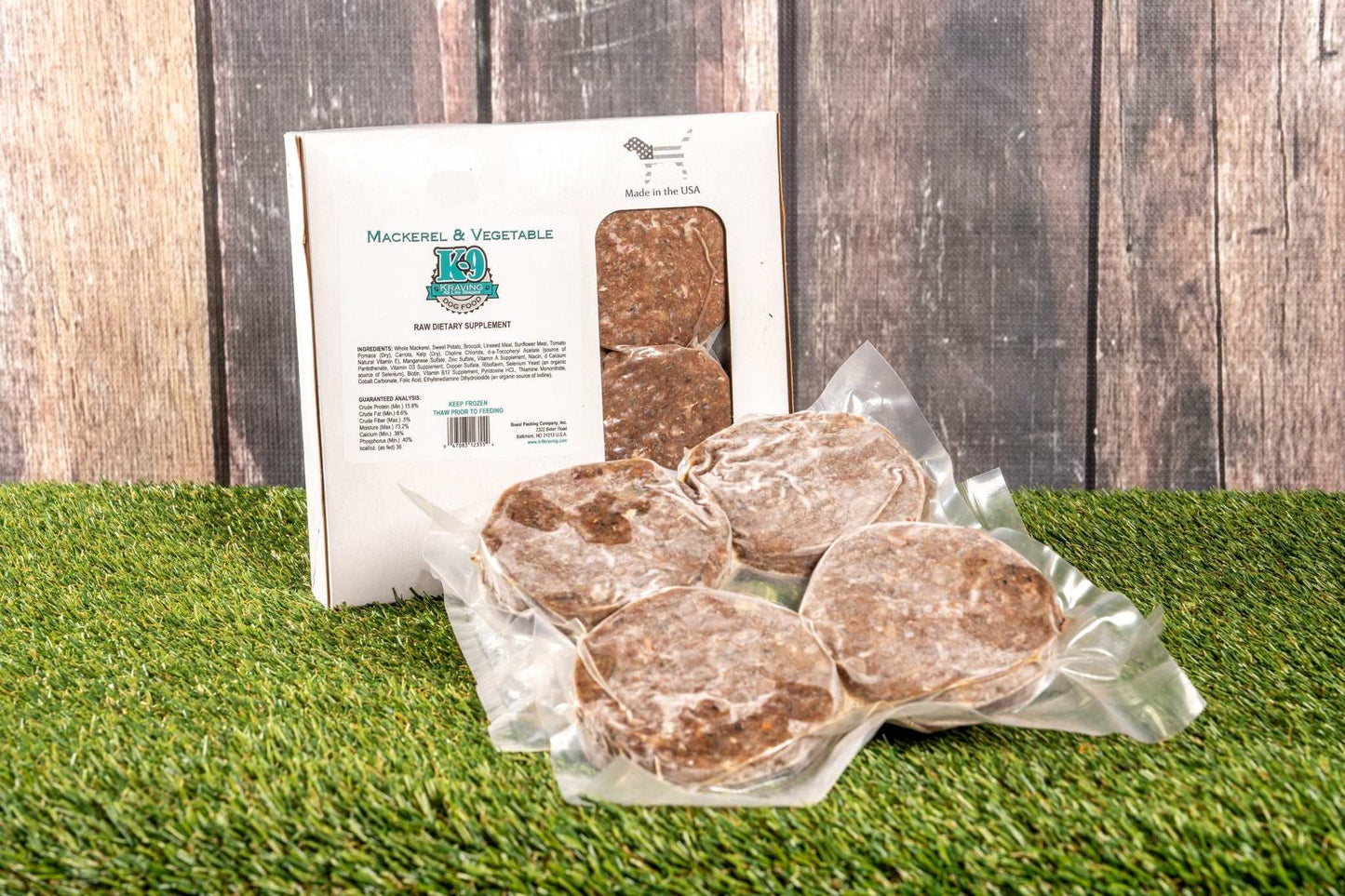 Mackerel & Vegetable Raw Dog Food packs on grass, eco-friendly packaging.