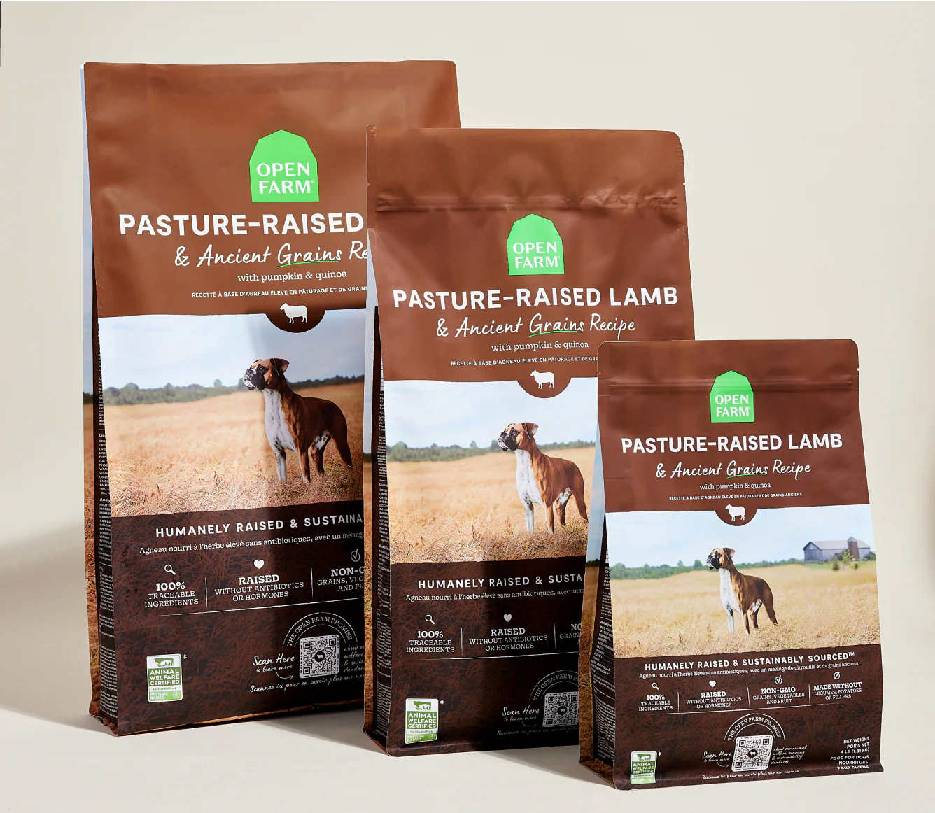 Three bags of Open Farm Pasture-Raised Lamb & Ancient Grain Recipe dog kibble featuring a dog in a field on the packaging.