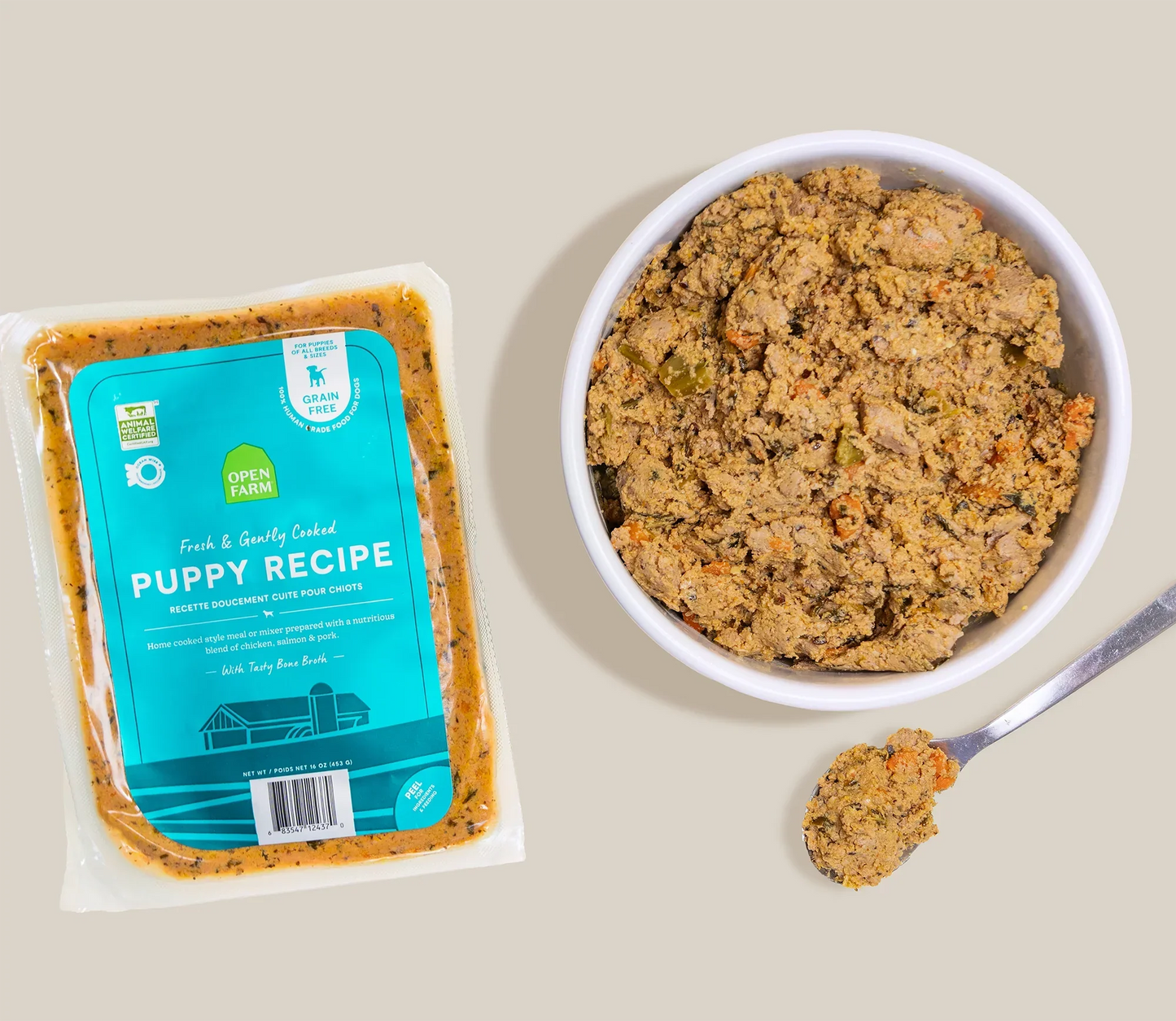 Puppy grain-free freshly crafted dog food with chicken, salmon, and bone broth in a sealed pouch and bowl.
