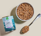Puppy Chicken & Salmon Pâté wet dog food, brown minced texture with a teal-and-white can label reading “Pâté”