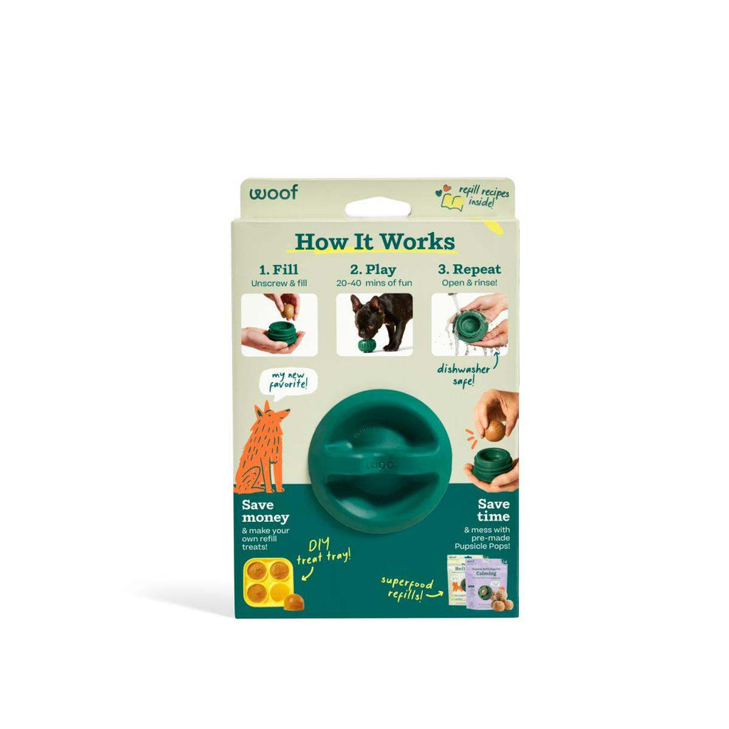 Pupsicle dog enrichment toy, teal-green rubber with a rounded weighted base and treat-opening slots, shown on packaging