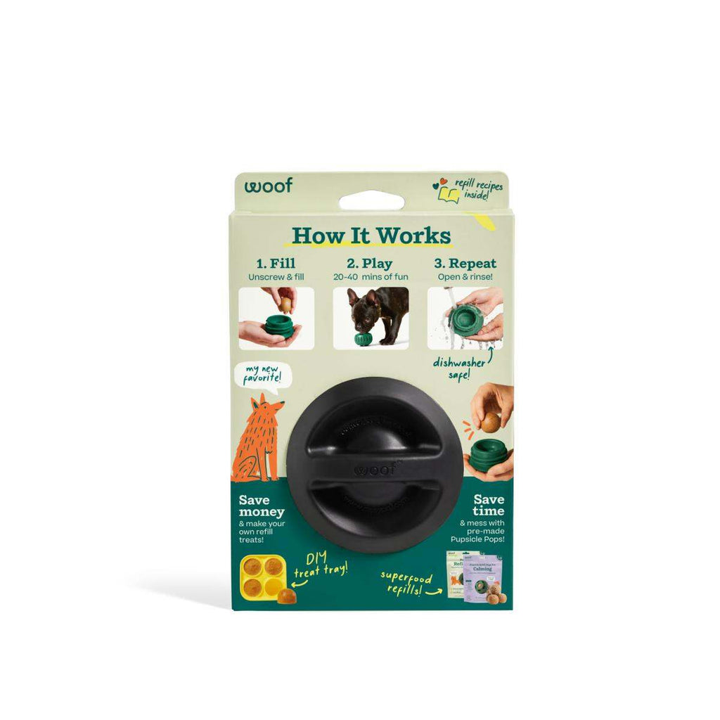 Pupsicle dog enrichment toy in black natural rubber, with a rounded shape, horizontal openings, and green retail packaging.