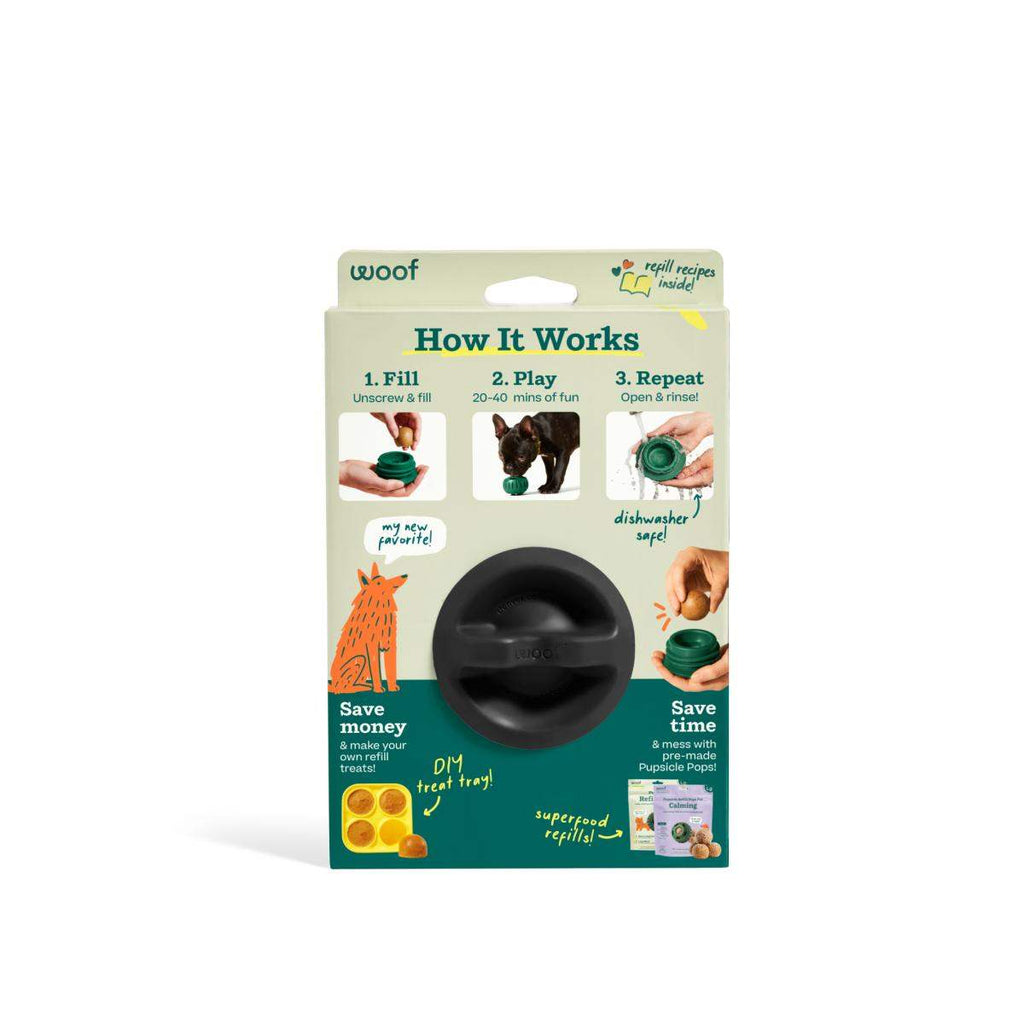 Pupsicle dog enrichment toy in black natural rubber, shown packaged with a round, slotted treat holder and refill instructions.