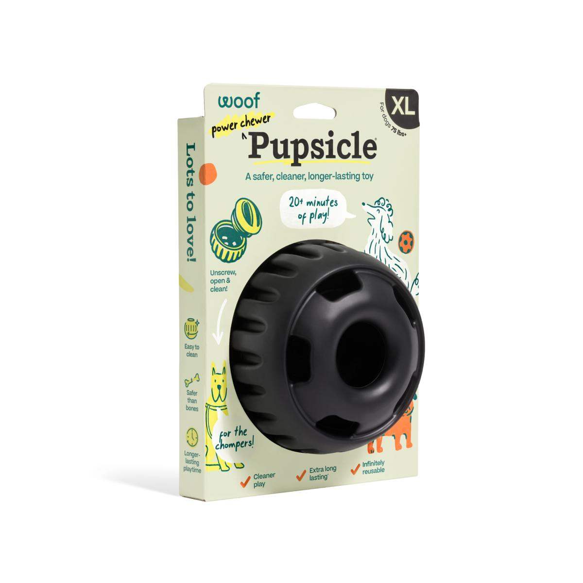 Pupsicle dog enrichment toy in black rubber, round weighted design with a large center opening, shown in XL packaging.