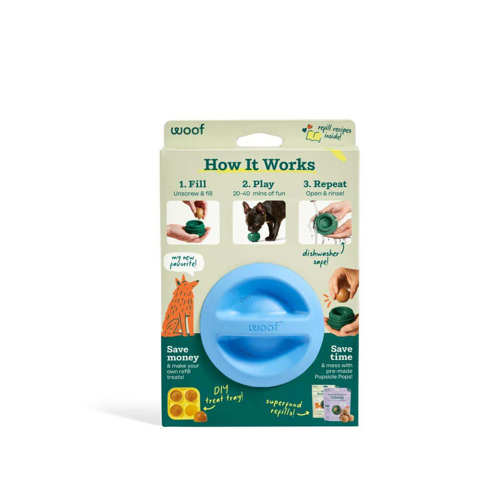 Pupsicle dog enrichment toy, blue non-toxic rubber sphere with a central slot, displayed in a cardboard package.