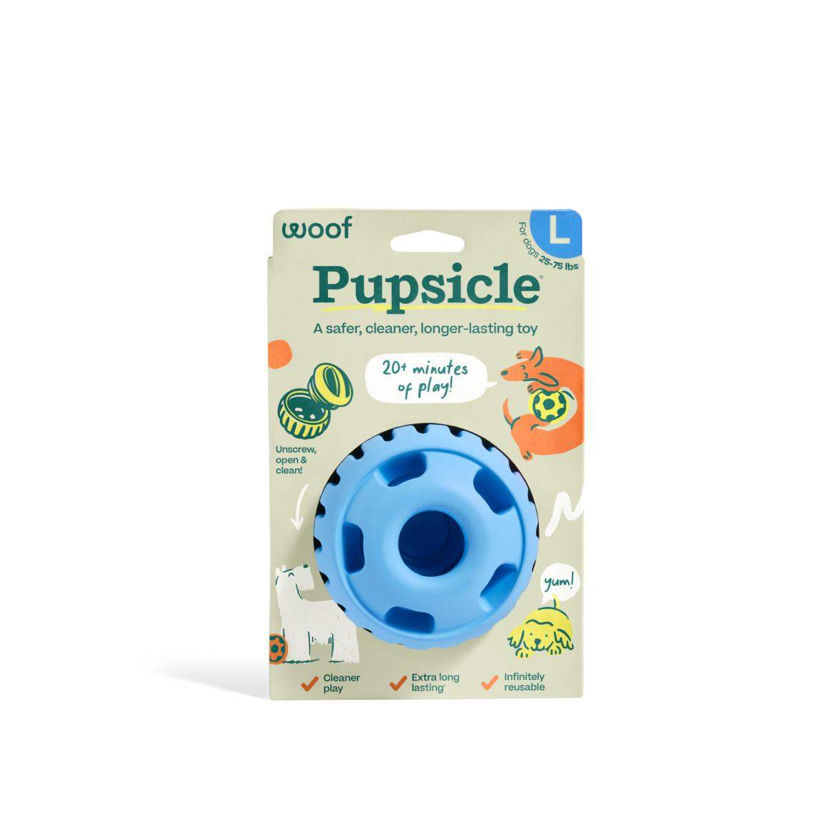 Pupsicle enrichment toy in bright blue natural rubber, with a round shape, molded treat slots and paper packaging.