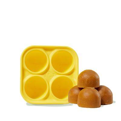 Pupsicle Treat Tray, yellow silicone tray with frozen dog treats.