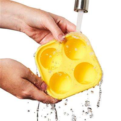 Pupsicle Treat Tray being washed under running water.