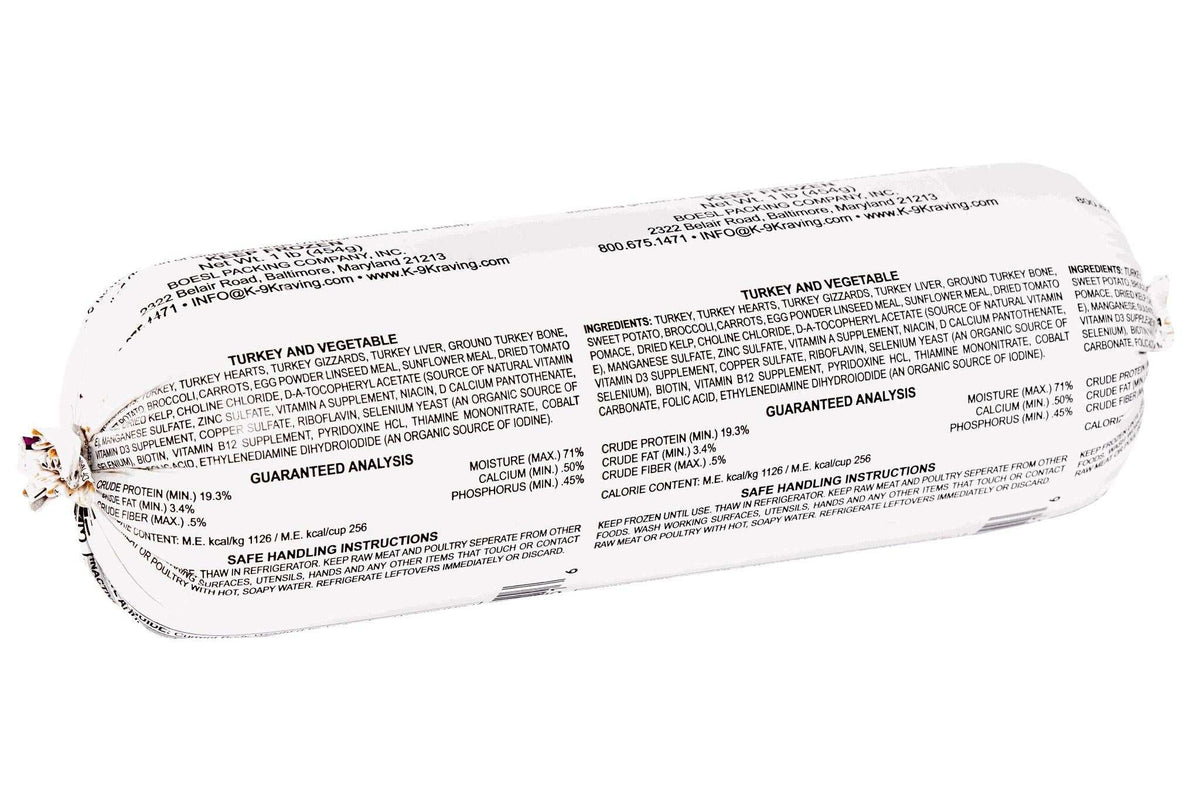 Raw dog food roll with white packaging and dense black printed ingredients and nutrition details, labeled Turkey and Vegetable.