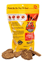 Beef K-9 Cookies in a yellow and orange resealable bag, with flat, brown, speckled baked treats displayed in front.