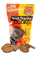Beef Trachea K-9 Cookies in an orange and yellow bag, with round, rough-textured brown treats visible through the package.
