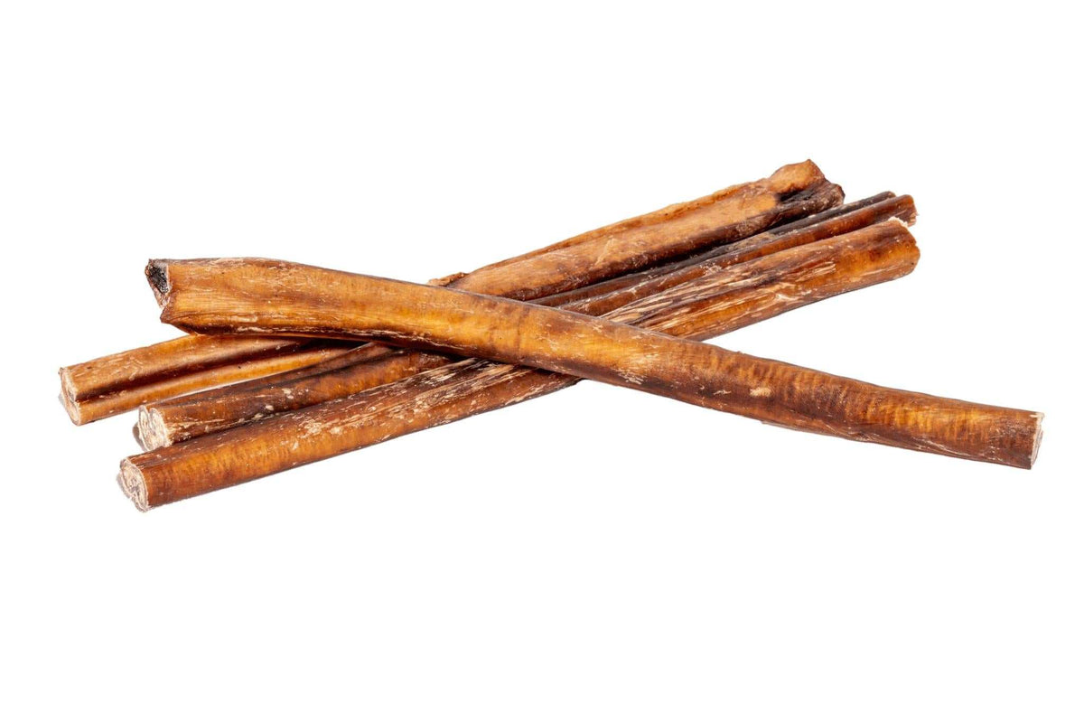 Dried Bully Stick chews in warm brown, with a natural ridged texture and long, slender shape crossed in a stack.