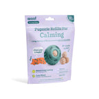 Dog treat refill pack in a lavender pouch, showing a teal treat-dispensing toy and round beige calming treats; labeled Calming Vitamin Pops.
