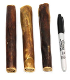Three Chewy Bulls dog treats made from beef esophagus next to a black Sharpie marker for size comparison