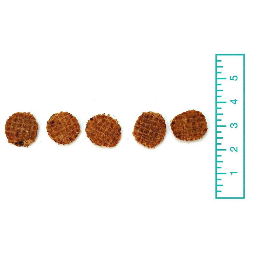 Chicken Flips are small round brown chicken treats with a coarse, textured surface and irregular edges.