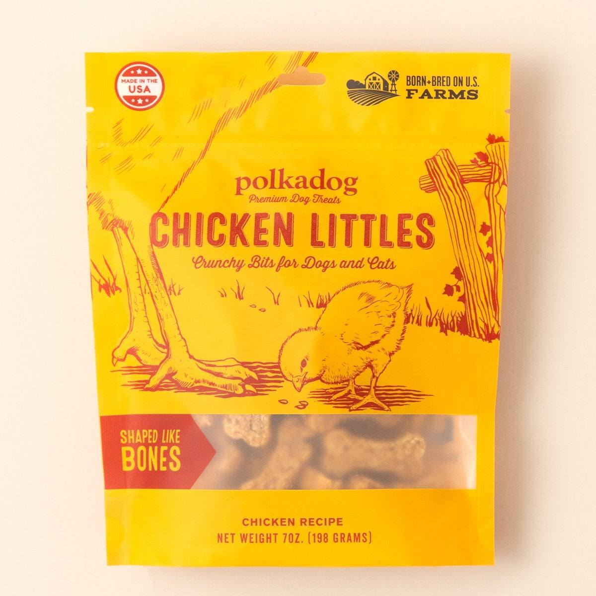Chicken Littles bone-shaped crunchy dog treats with chicken breast, brown rice, and potato flour in yellow resealable bag