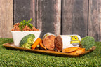 K-9 Kraving Chicken & Vegetable Raw Dog Food with broccoli, carrots, and sweet potatoes on a wooden tray.