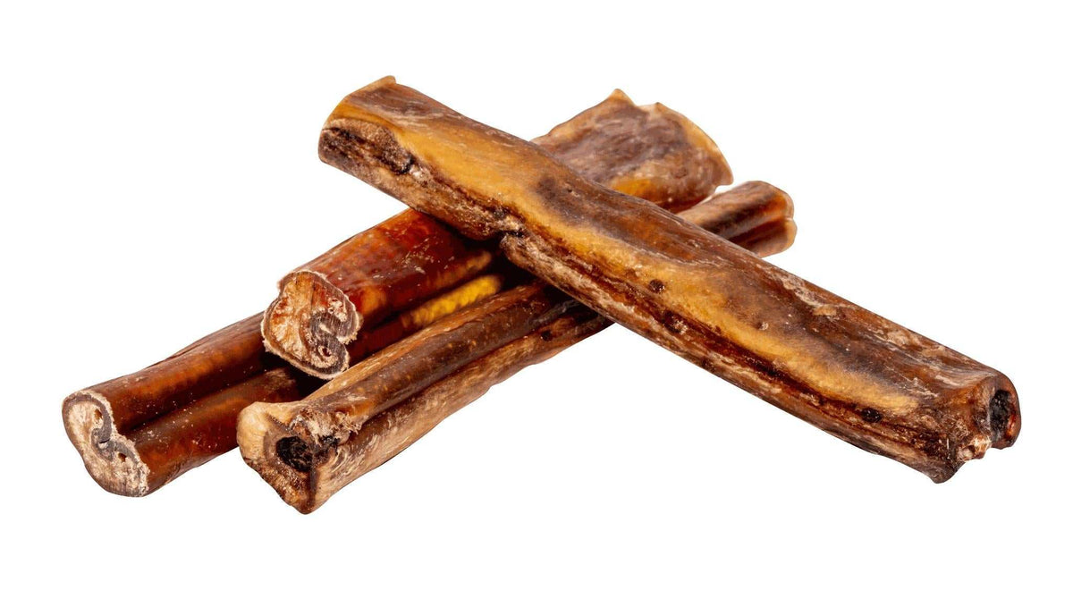 Bully Stick dog chews in varied lengths, dried dark reddish-brown beef with a firm, ridged texture and cut ends.