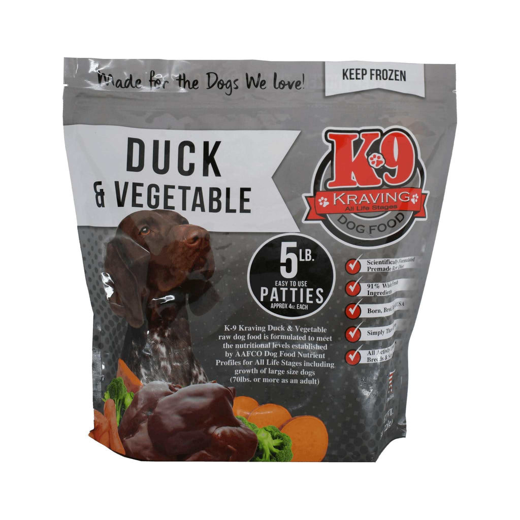 Dog food package for Duck & Vegetable frozen raw patties, in a gray bag with red and white branding and food imagery.