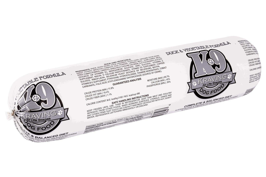 Frozen raw Duck dog food in a white plastic tube with bold black-and-gray K-9 Kraving labels and printed product details.