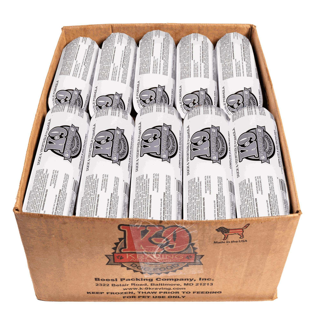 Duck raw dog food rolls in white printed wrappers, packed upright in a brown cardboard box with K-9 branding.