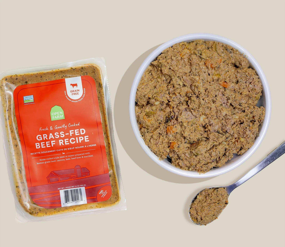 Grass-Fed Beef dog food, freshly cooked brown ground food with visible herb flecks in a bowl beside its sealed pack.