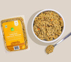 Harvest Chicken Grain-Free fresh dog food with a yellow-orange label, packaged in a clear tray beside a bowl of chunky food.