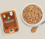 Pasture-Raised Lamb dog food, brown gently cooked minced recipe in a sealed rectangular pack beside a white bowl.