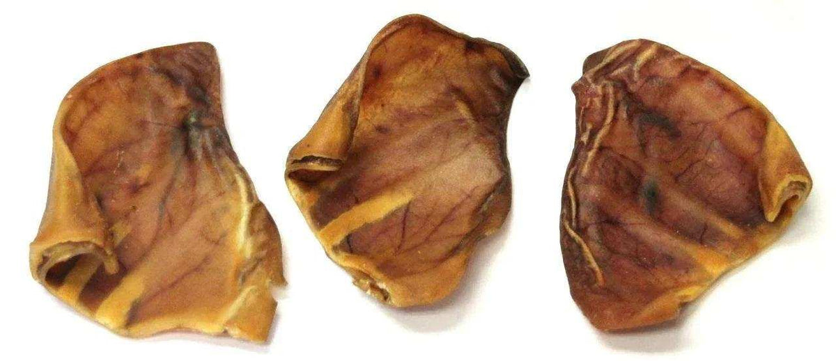 Pig Ear chew made from natural dried pig skin, with a leathery texture, amber-brown colour, and irregular ear shape.