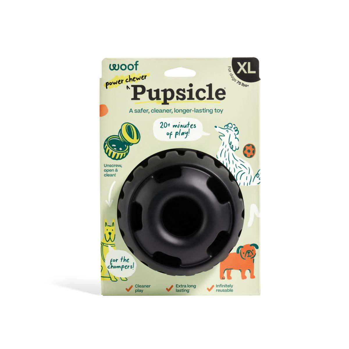Pupsicle dog enrichment toy in black rubber, featuring a round hollow center and scalloped rim, packaged in size XL.