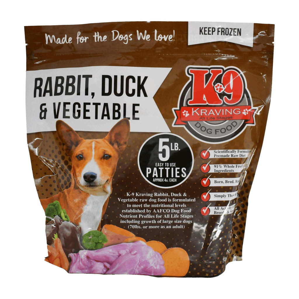 Rabbit Duck raw dog food in a brown and white printed plastic pouch, showing meat patties and vegetables on the label
