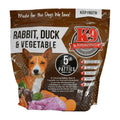 Rabbit Duck raw dog food in a brown and white printed plastic pouch, showing meat patties and vegetables on the label