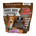 Rabbit Duck raw dog food in a brown and white printed plastic pouch, showing meat patties and vegetables on the label