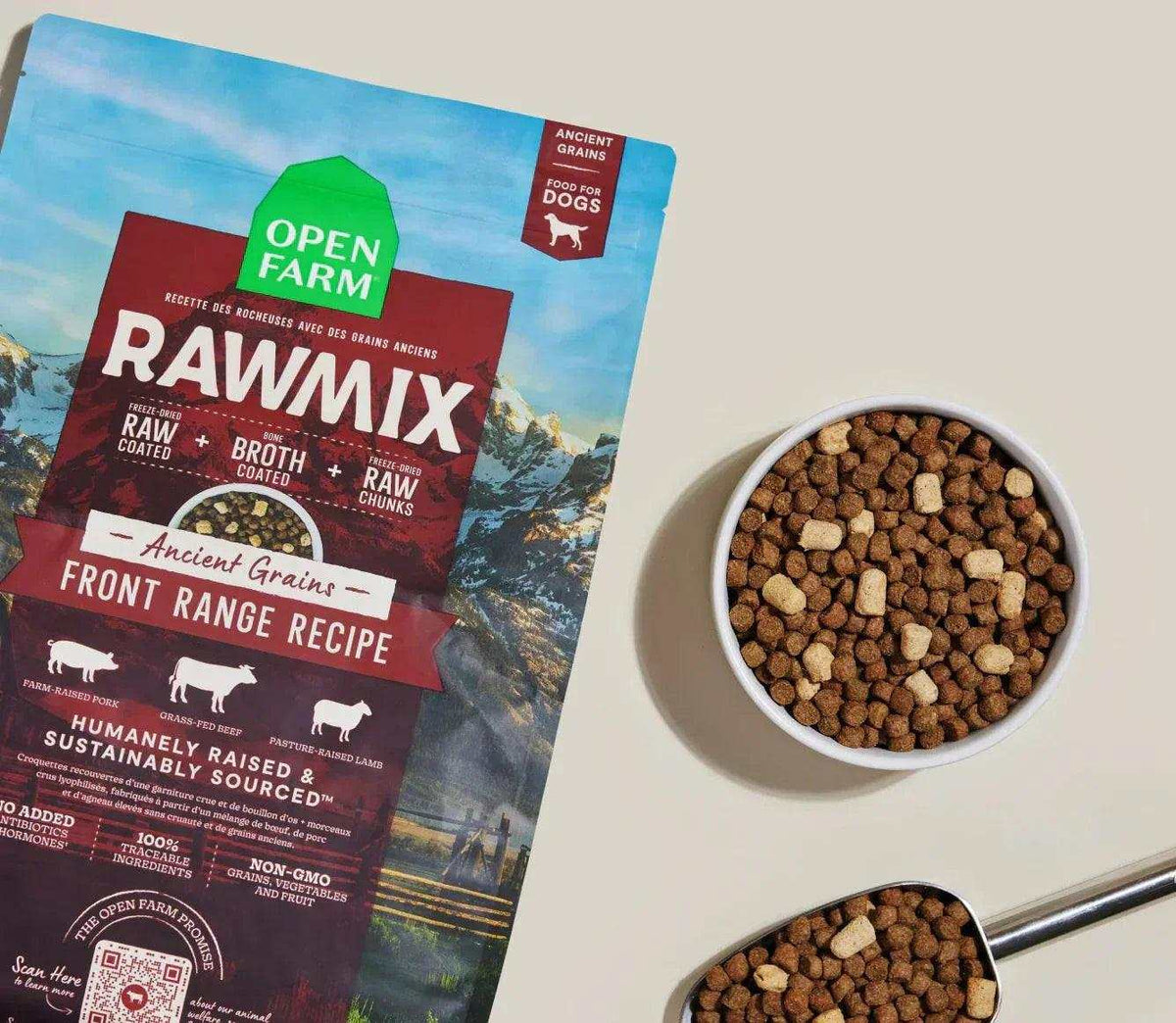 Dog kibble with RawMix Front Range packaging, a white bowl of brown and tan rounded pieces beside it.