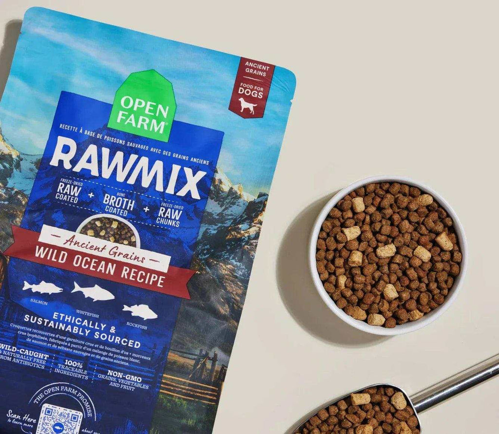 Dog kibble in brown crunchy morsels, with a blue RawMix Wild Ocean ancient grains recipe bag and freeze-dried chunks.