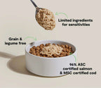 Salmon & Cod Topper dog food, pale beige mousse over brown kibble in a white ceramic bowl, grain- and legume-free formula