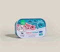 Rectangular metal tin of Salmon & Cod Topper for dogs with pink and blue fish illustrations and pull-tab lid
