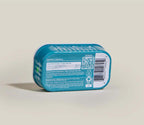Salmon & Cod Topper dog food in a turquoise plastic tray, with a white barcode label and printed product details.